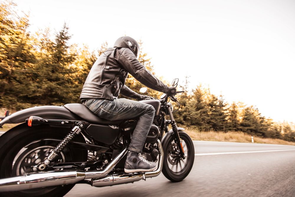 person driving motorcycle on road