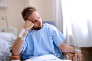 man sitting in hospital room