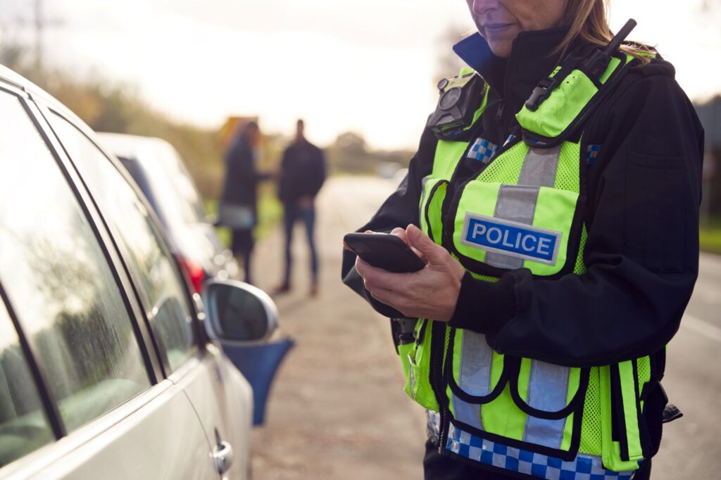 police officer recording details of wreck