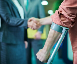 injured man shaking lawyer's hand