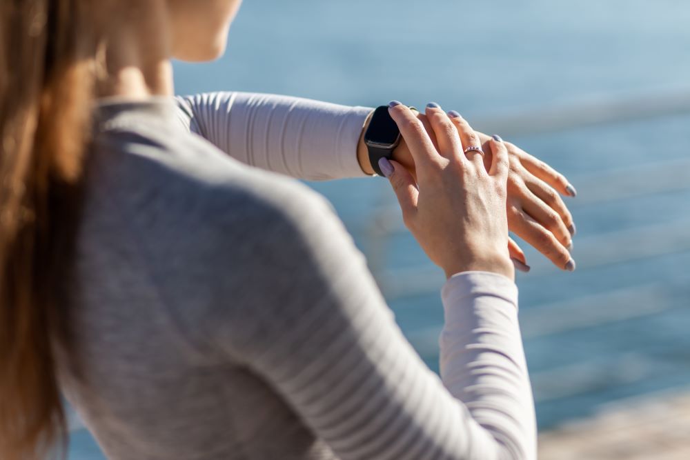 female checking smart watch