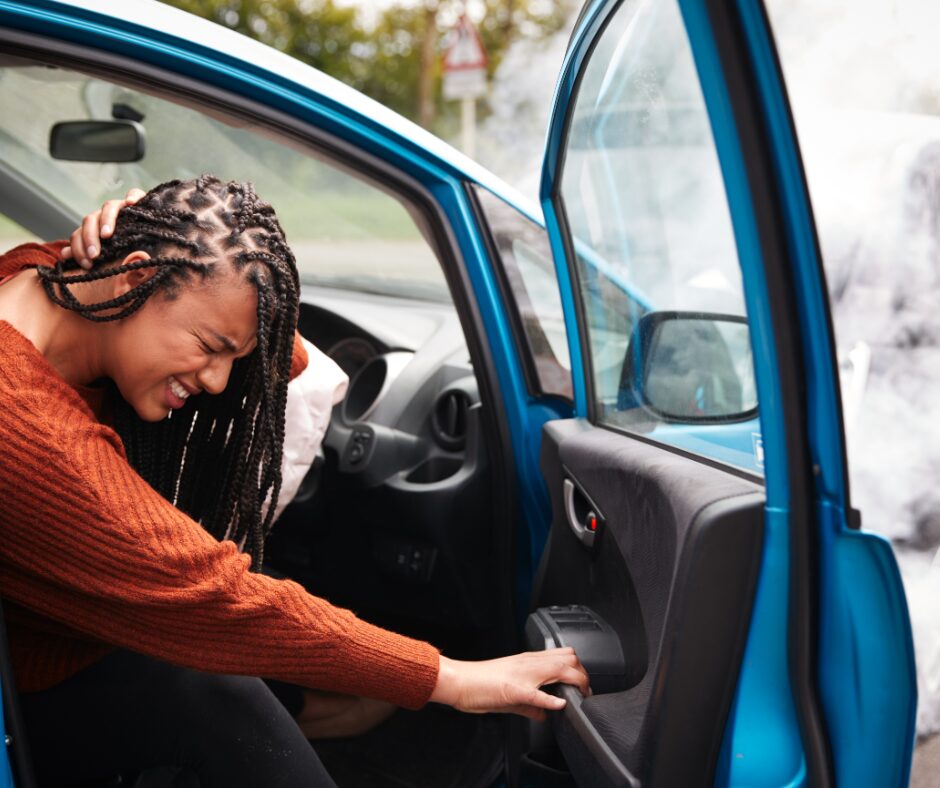 girl grabbing neck after car wreck