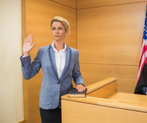 woman taking oath in courtroom